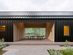 Modern dogtrot house plan interior — open-concept living and dining with vaulted ceiling