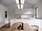 Modern dogtrot house plan interior — bright open living space with sliding glass doors to the deck