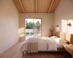 Primary bedroom with wood accents in 2 bed 2 bath Japandi house plan