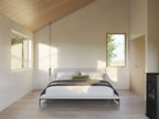 Garage apartment interior — studio living space with natural light from a 12-foot window