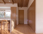 Front entry of 2 bed Japandi minimalist house plan with wood door