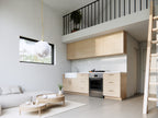 Micro cabin ADU interior — open living space with kitchenette and sliding glass door