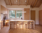 L-shaped kitchen with center island in Japandi minimalist house plan