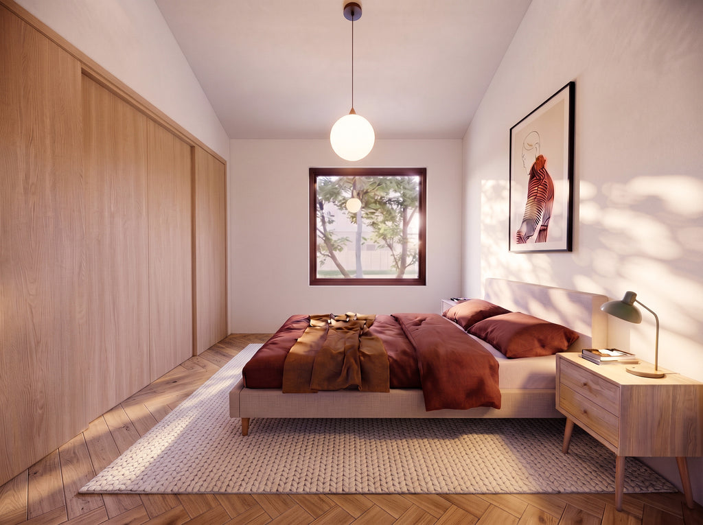 Primary accessible bedroom in the 2 bedroom wheelchair accessible house plan, with two windows, a closet and clear approach on both sides of the bed