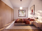 Primary accessible bedroom in the 2 bedroom wheelchair accessible house plan, with two windows, a closet and clear approach on both sides of the bed