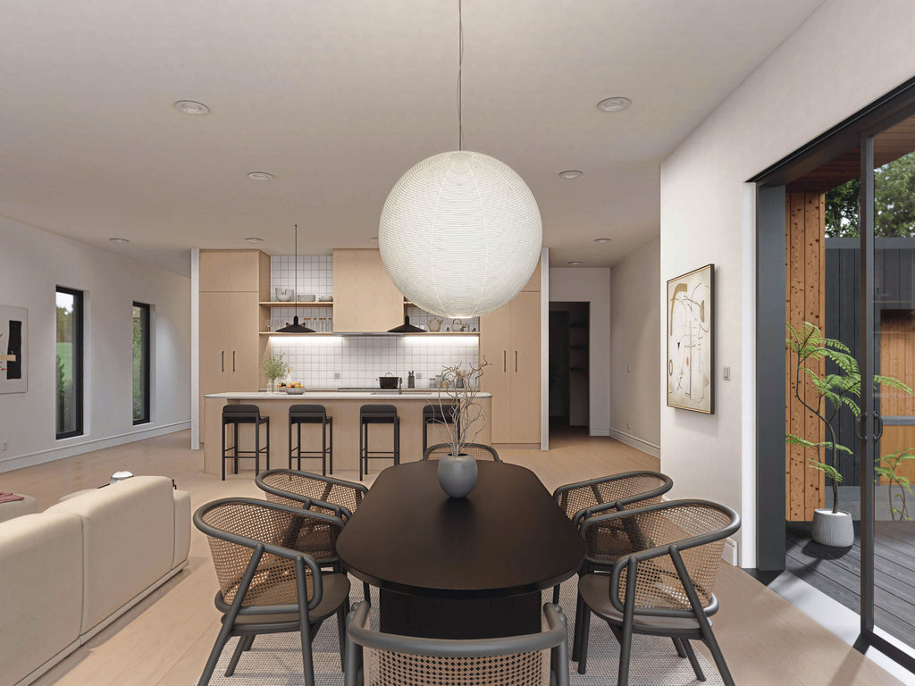 Barndominium floor plan interior showing dining area open to kitchen island and living space with globe pendant light