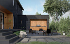 Modern barn house plan outdoor kitchen — wood accent wall, fire pit seating and gravel patio by the lake