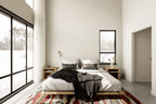 Midcentury home plan primary bedroom with floor-to-ceiling black-frame windows, high ceilings and winter landscape views