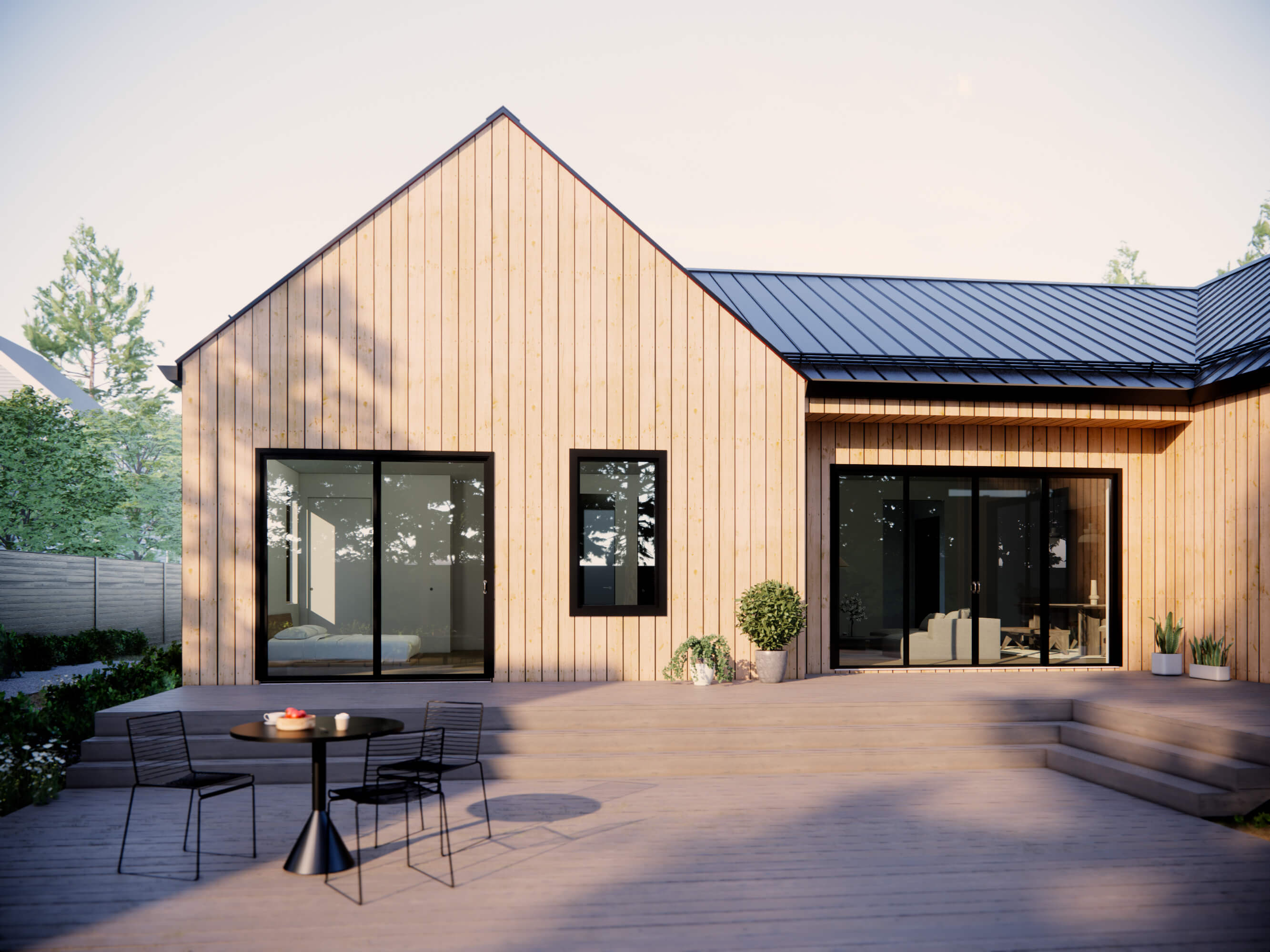 Southern modern farmhouse house plan rear patio with wide wood deck, natural wood vertical siding, black-frame sliding glass doors and gabled metal roof