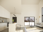 2 story cabin house plan interior — loft overlooking the open living and dining area