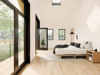 Modern loft house plan primary suite — second-floor bedroom with glass door opening to the balcony