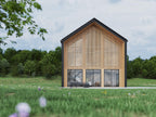 Lake barndominium house plan gable-end exterior — 4 bedroom modern barndominium with double-height windows