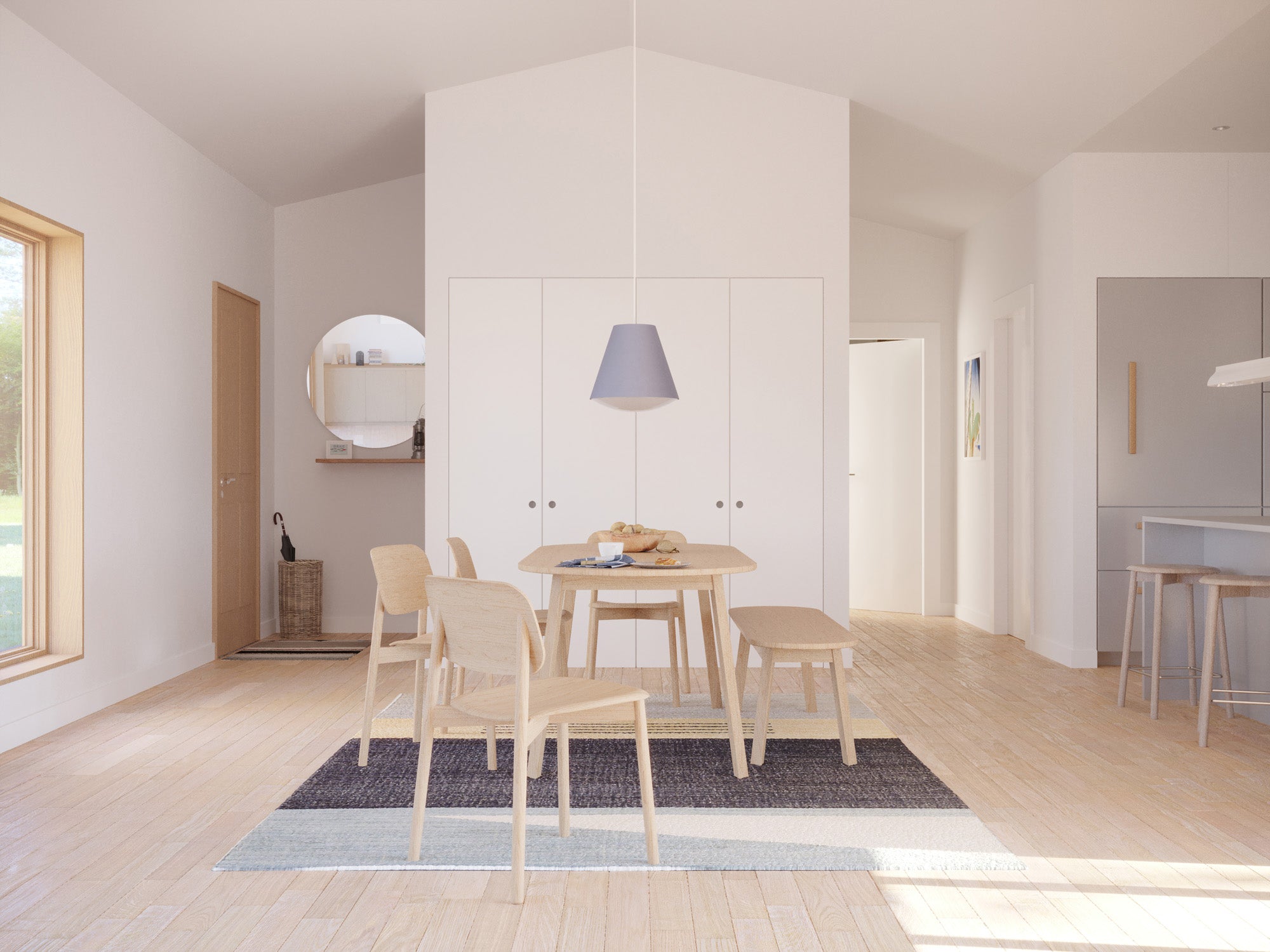 Open-plan dining area with vaulted white ceiling, Scandinavian light oak dining table and chairs, navy pendant light, full-height white storage unit, light oak floor, and view through to kitchen island