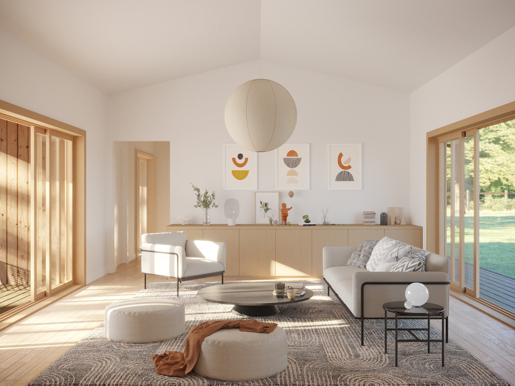 Sun-filled open-plan living room with vaulted white ceiling, central concrete fireplace with log storage, oak floor, paper globe pendant, neutral sofa and armchair, and large wood-framed windows on both sides