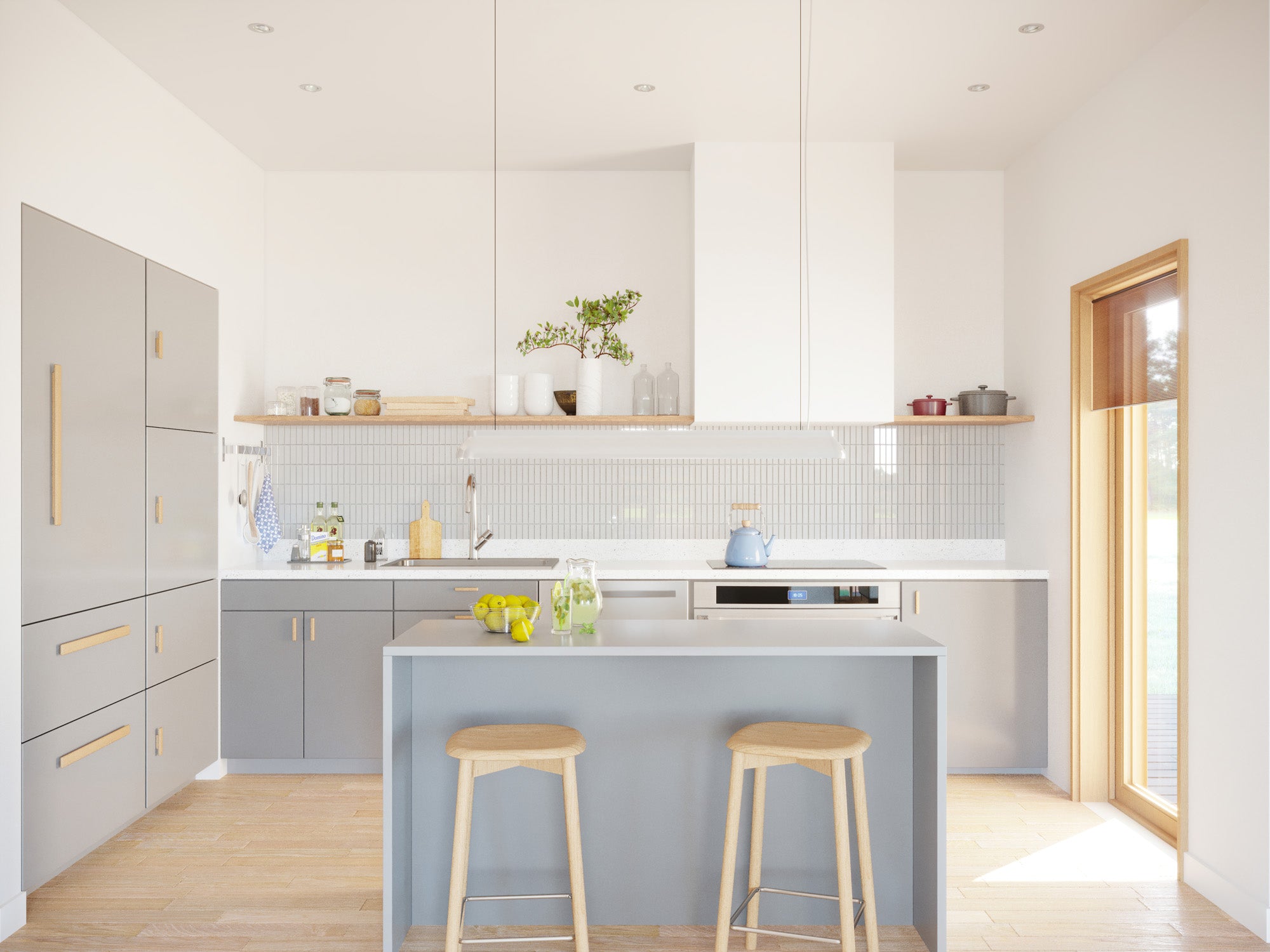 Bright modern kitchen interior with grey flat-front cabinets, brass hardware, white tile backsplash, open wood shelving, grey island with bar stools, and light oak herringbone floor