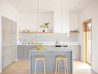 2 bed 2 bath small house plan interior — modern kitchen with grey cabinets, island, and oak floors