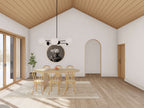 Modern cabin floor plan dining room with vaulted wood plank ceiling, arched doorway detail, natural wood table and large sliding glass door with winter views