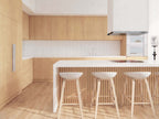 Nordic barndominium kitchen with natural wood cabinetry, white quartz island with slatted base, white tile backsplash and bar stool seating