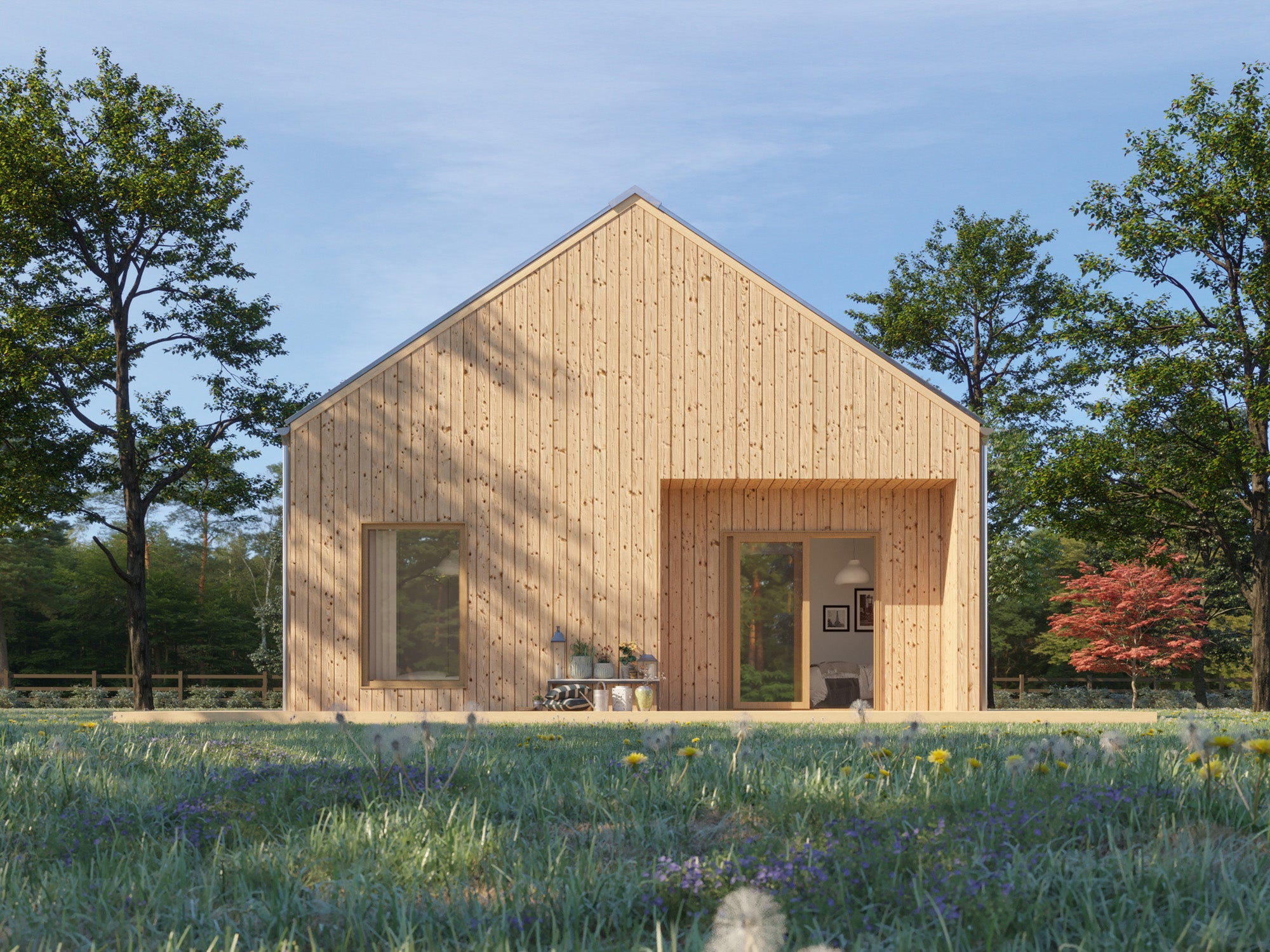 Small Scandinavian-style gable-end house with light natural wood vertical cladding, pitched roof, and recessed front entrance set in a wildflower meadow on a sunny day